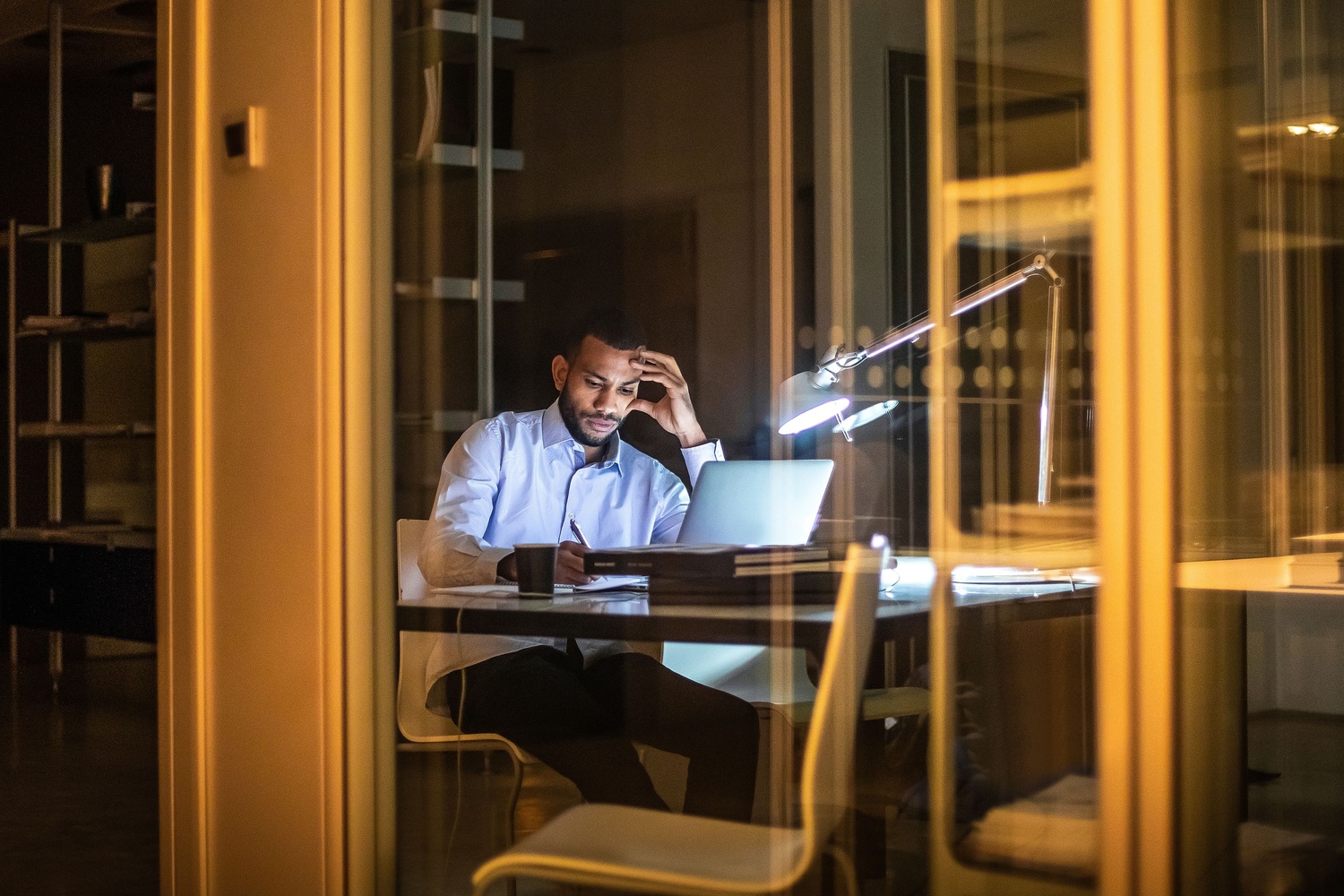 Professional working at a desk in an office setting, representing EY Law legal services and business support.